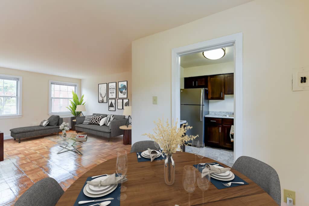 view of dining area with table, chairs and views of kitchen and living area at the colonnade apartments in washington dc