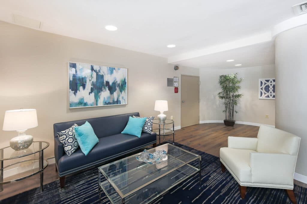 lobby with social seating, modern lighting and hardwood floors at hilltop house apartments in washington dc