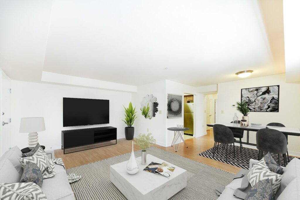living area with sofa, coffee table, credenza, tv, dining area and view of kitchen at jasper place apartments in washington dc