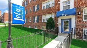 exterior entrance, awning and welcome signage at jetu apartments in washington dc