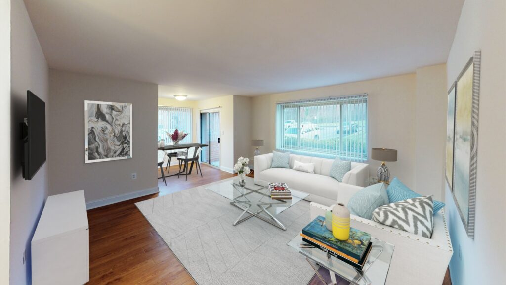 living area at penn view apartments with sofa, decorative rug, tv, credenza, dining area and large windows