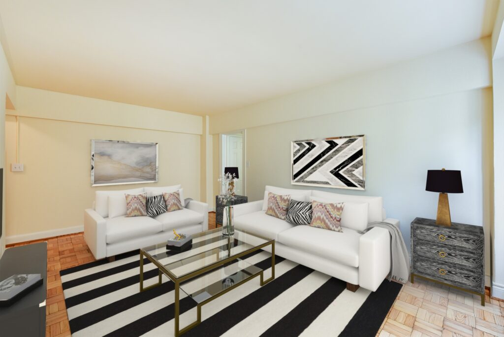 living area at sherry hall apartments with sofa, decorative rug, modern artwork and hardwood flooring.