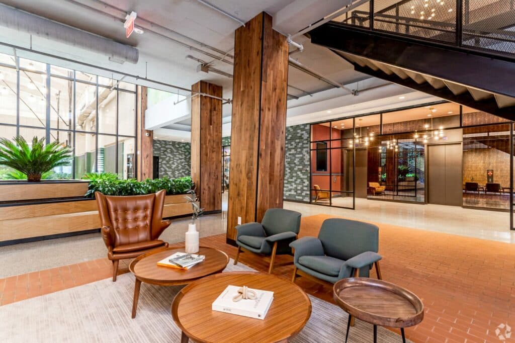 lobby lounge with social seating and rustic finishes at the garrett of the collective washington dc apartments