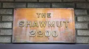 close up of the shawmut apartment building bronze signage in washington dc