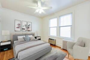 bedroom with wood floors, large windows and ceiling fan at 3213 Wisconsin apartments in cleveland park washington dc