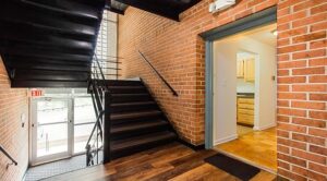 interior hallway with stairs and large windows at 5600 Chillum place apartments in washington dc