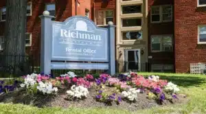 the richman apartments monument sign and exterior view of brick apartment building