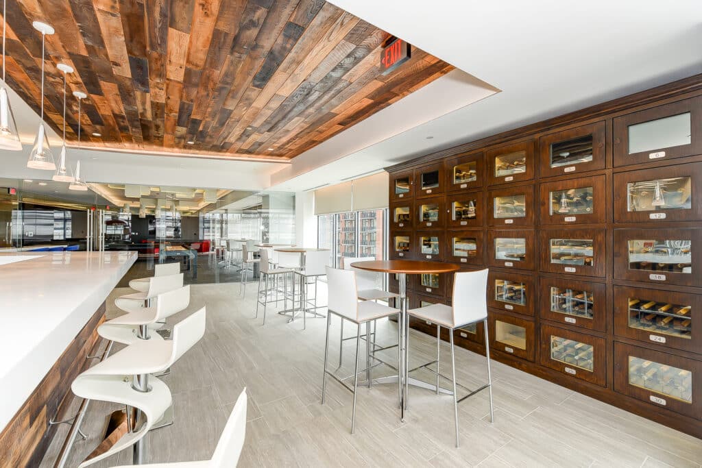 wine locker lounge with bar, social seating and large windows at agora apartments in Washington dc