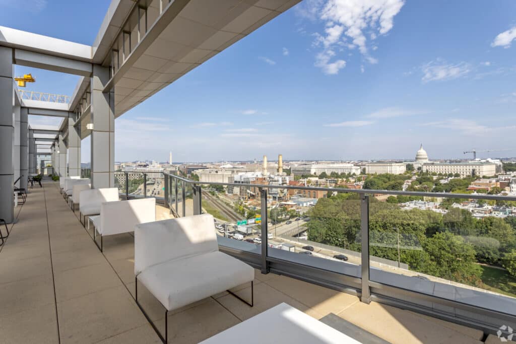 rooftop lounge with social seating and view of the united states capitol building at agora apartments in washington dc