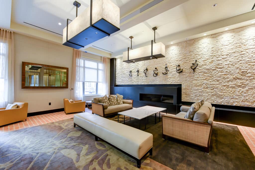 resident lounge with social seating, fire place and modern artwork at park chelsea apartments in washington dc