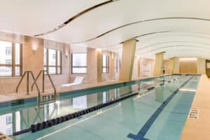 indoor lap pool with chaise lounge chairs at park chelsea apartments in washington dc