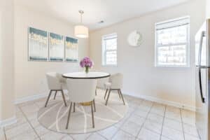 dining area with table, chairs, tile flooring and windows at sheridan station south townhomes apartments in washington dc