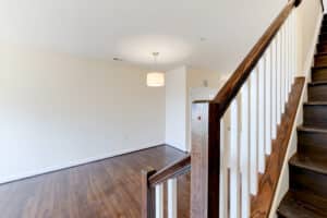 vacant living area with wood flooring and view of stairs leading to bedrooms at sheridan station south townhome apartments in washington dc