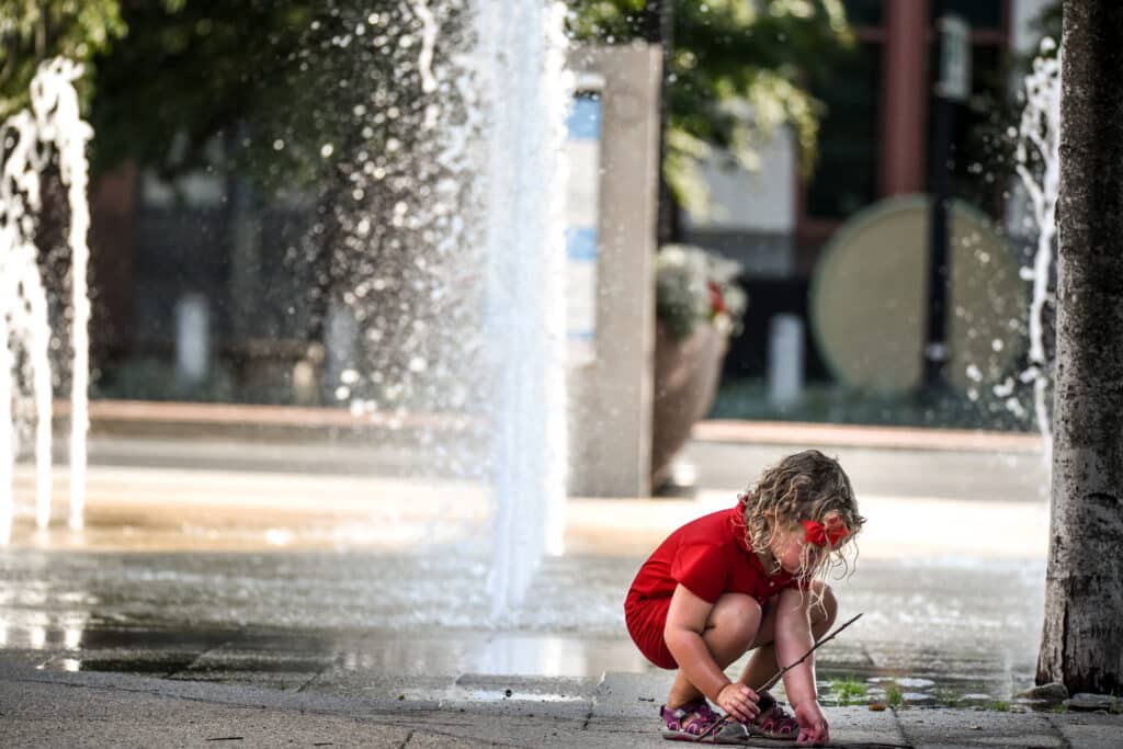 child playing in fountains at canal park in washington dc