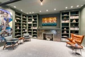 library lounge with social seating, books and fire place at the garrett apartments at the collective in washington dc