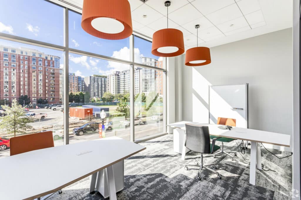 co working space with desks, office chairs and large windos at the garrett apartments in washington dc
