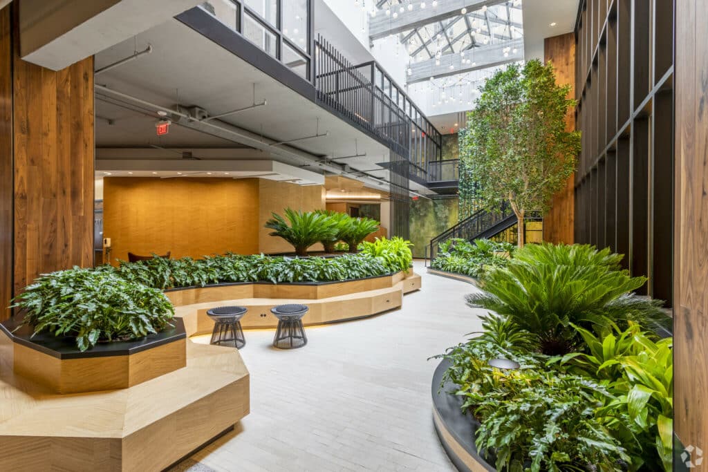 atrium with trees, plants and social seating at the garrett apartments in washington dc