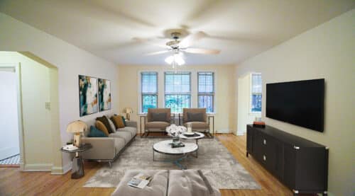 living area with sofa, coffee table, credenza, tv, ceiling fan and hardwood floors at 3101 pennsylvania apartments in randle highlands washington dc