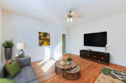 living area with sofa, coffee table, tv, credenza, ceiling fan and hardwood floors at chatham courts apartments in adams morgan washington dc